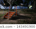 Playground equipment in an empty park at night 143491900