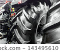 Tractor tire details showcased at an agricultural equipment exhibition in a large indoor venue 143495610