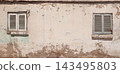 Old windows of a traditional Egyptian house, featuring weathered walls, aged architectural details, rustic character and authentic historic atmosphere 143495803