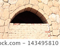 Old Egyptian sand-colored textured wall with an authentic weathered surface, rough plaster and natural imperfections. Architectural texture background for design and creative projects 143495810