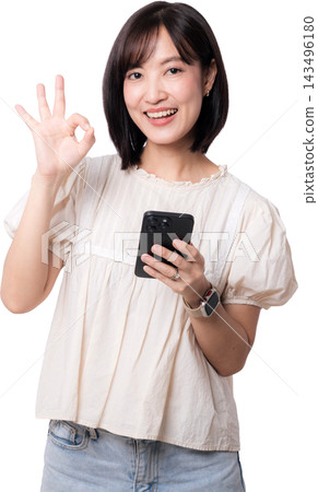 Happy smiling asian woman holding smartphone making ok hand sign showcasing modern artificial intelligence digital mobile communication technology isolated on transparency background Happy smiling asian woman holding smartphone making ok hand sign showcasing modern artificial intelligence digital mobile communication technology isolated on transparency background 143496180