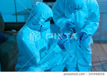 Forensic expert collecting a blood sample at a crime scene for laboratory analysis, DNA testing, criminal investigation, evidence examination, and justice. Forensic expert collecting a blood sample at a crime scene for laboratory analysis, DNA testing, criminal investigation, evidence examination, and justice. 143498038