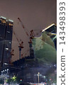 Night view of the area around Tokyo Station, construction site cranes 143498393