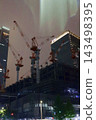 Night view of the area around Tokyo Station, construction site cranes 143498395