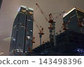 Night view of the area around Tokyo Station, construction site cranes 143498396