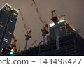 Night view of the area around Tokyo Station, construction site cranes 143498427