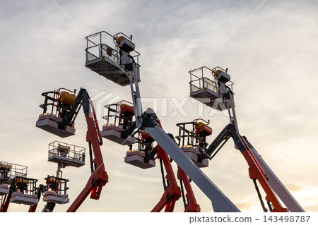 Articulate boom lift with blue sky background, Aerial platform lift telescopic boom lift hydraulic boom lift, Mobile construction crane, Construction boom lifts Articulate boom lift with blue sky background, Aerial platform lift telescopic boom lift hydraulic boom lift, Mobile construction crane, Construction boom lifts 143498787