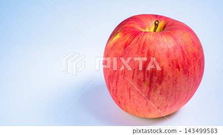 A photograph of a Sun Tsugaru apple against a white background. A photograph of a Sun Tsugaru apple against a white background. 143499583