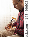 Senior Man Taking Medication at Home 143499602