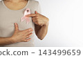 Person Holding Pink Ribbon for Breast Cancer Awareness 143499659