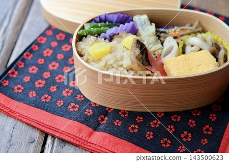Autumn Japanese food bento box with sticky rice, served in a bentwood box. Autumn Japanese food bento box with sticky rice, served in a bentwood box. 143500623