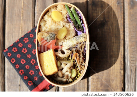 Autumn Japanese food bento box with sticky rice, served in a bentwood box. Autumn Japanese food bento box with sticky rice, served in a bentwood box. 143500626