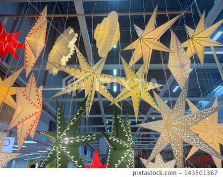 Hanging paper star decorations in festive store display. Hanging paper star decorations in festive store display. 143501367