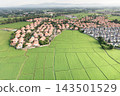 Residential property expansion across green farmland in suburban Chiang Mai. 143501529