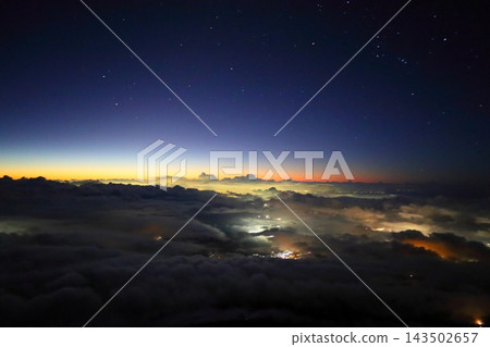 A sky full of stars and the horizon painted in the colors of the sunrise. A sky full of stars and the horizon painted in the colors of the sunrise. 143502657
