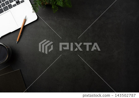 Top view of dark stone desk background with laptop, notebook and office supplies with large copy space Top view of dark stone desk background with laptop, notebook and office supplies with large copy space 143502787
