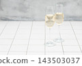 Stylish champagne glasses. White tiles. 143503037