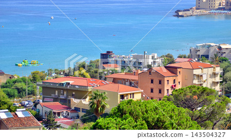 Cefalu, Italy. 22 August 2026. A panoramic view of the town, situated right by the sea and its urban development amidst the greenery 143504327