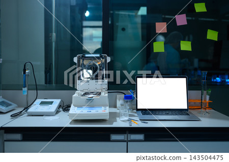 Laboratory Workstation with Analytical Balance, Laptop Blank Screen, and Scientific Equipment in Modern Lab 143504475