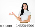 Young Asian Woman Smiling and Pointing to Copy Space on White Background 143504500