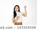 Excited Asian Girl Celebrating Victory with Raised Fist on White Background 143504506