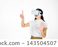 Young Asian Woman Using VR Headset Reaching Hands in Virtual Reality Experience on White Background 143504507