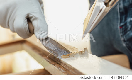 Carpenter at work, restoring an old wooden window. Carpentry. Carpenter at work, restoring an old wooden window. Carpentry. 143504905