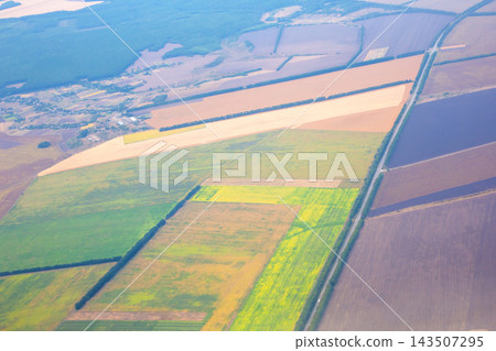 Farm fields and landscape view from above in rural area showing different colors and patterns Farm fields and landscape view from above in rural area showing different colors and patterns 143507295