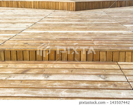 Multi level wooden flooring with weathered planks and stepped terrace details 143507442