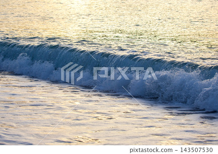 Waves gently rolling onto the shore at a beach in Turkey during the late afternoon Waves gently rolling onto the shore at a beach in Turkey during the late afternoon 143507530