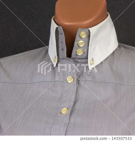 Close up of a button-up shirt with a contrasting collar design on display Close up of a button-up shirt with a contrasting collar design on display 143507533