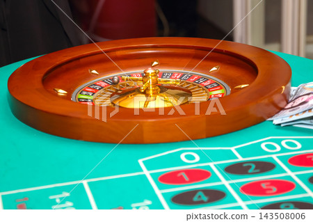 Roulette wheel and chips on a green casino table during a gaming session Roulette wheel and chips on a green casino table during a gaming session 143508006