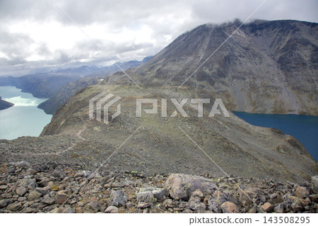 Mountain landscape in Norway with lakes and rocky terrain under a cloudy sky Mountain landscape in Norway with lakes and rocky terrain under a cloudy sky 143508295