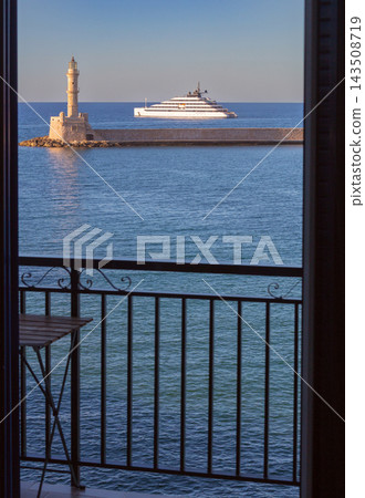 Luxury Superyacht and Venetian Lighthouse in Chania, Crete, Greece Luxury Superyacht and Venetian Lighthouse in Chania, Crete, Greece 143508719