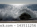 Powerful Wave Exploding Against Rock on Mediterranean Beach 143511256