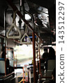 Close-up of the hand straps arranged at equal intervals inside a route bus. 143512297