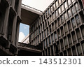 A retro building with distinctive, rounded windows arranged in a regular pattern. 143512301