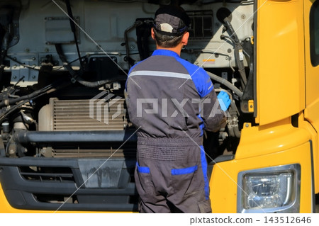 Image of a large truck undergoing maintenance. Image of a large truck undergoing maintenance. 143512646