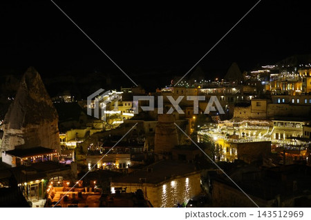 The historic district of Cappadocia, Turkey, with its unique rock formations and city lights at night. The historic district of Cappadocia, Turkey, with its unique rock formations and city lights at night. 143512969