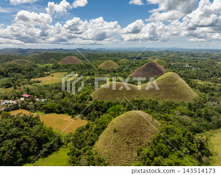 Lush green dome shaped hills forming the famous geological formation known as the Chocolate Hills in Bohol, Philippines Lush green dome shaped hills forming the famous geological formation known as the Chocolate Hills in Bohol, Philippines 143514173