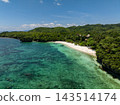 Clear blue water meets a white sand beach surrounded by lush green hills. Anda, Bohol, Philippines 143514174