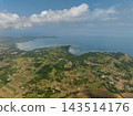 Green rolling hills meet the blue sea in this perspective of the coastline in Bohol, Philippines 143514176