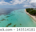 Turquoise water, palm tree lined shore, and resort area of a coastal destination in Panglao, Bohol, Philippines 143514181