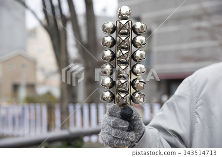 A man's hand holding a sleigh bell. A man's hand holding a sleigh bell. 143514713