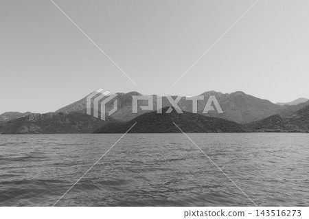 Black and white landscape view across Lake Skadar with distant mountains 143516273