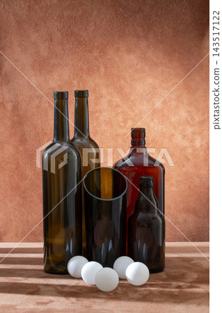 Still life with glass objects and white spheres on a colored background Still life with glass objects and white spheres on a colored background 143517122