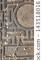 Old metal manhole cover on asphalt texture close up 143518016
