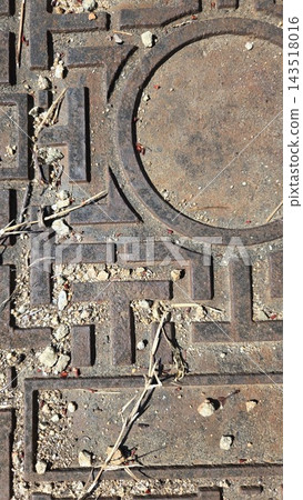 Old metal manhole cover on asphalt texture close up Old metal manhole cover on asphalt texture close up 143518016