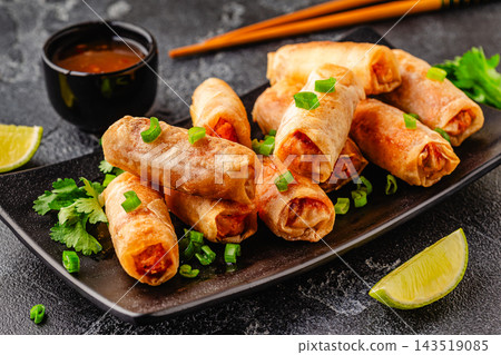 Fried spring rolls served with sauce and lime Fried spring rolls served with sauce and lime 143519085