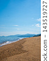A beautiful sandy beach landscape with a clear blue sky and calm sea. 143519727